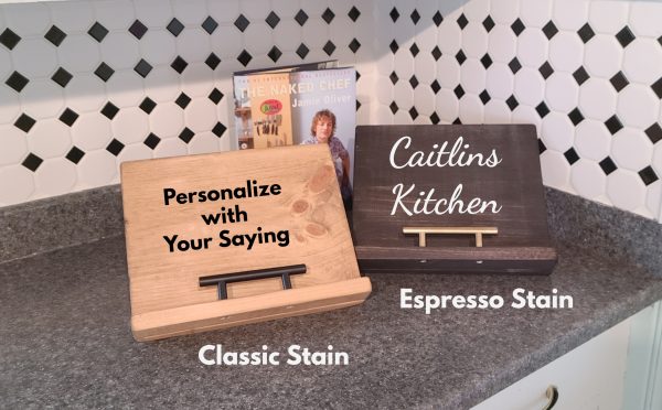 Cookbook Ipad Recipe Stands. One finished in Classic Colour with text, Personalize with your Saying, Second finished in Espresso with White Text that says Caitlins Kitchen